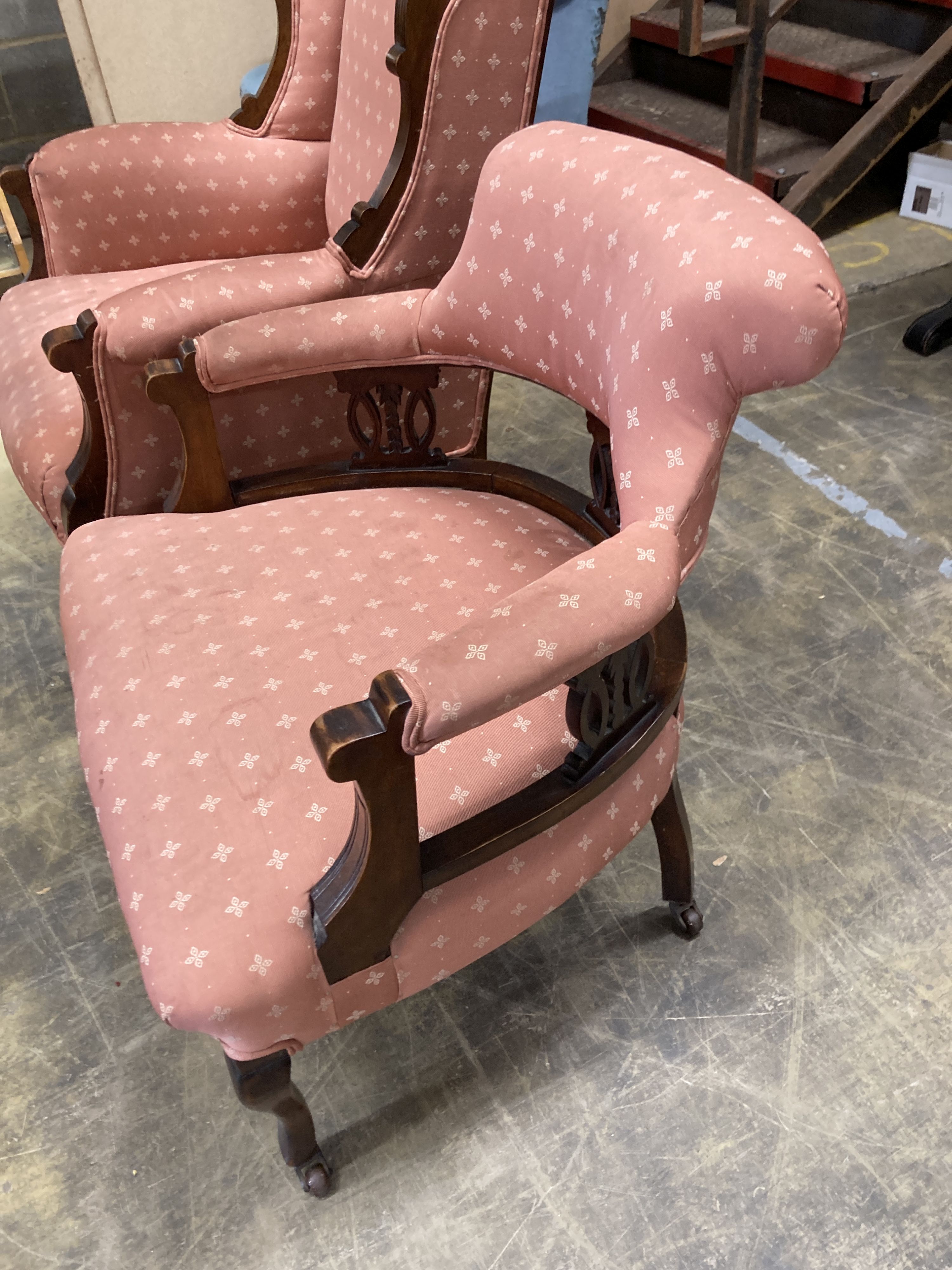 A late Victorian mahogany armchair together with a matching tub framed elbow chair